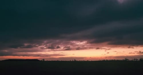 Sky Turns Dramatic Over Empty Field At Sunset Time Lapse