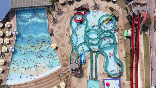 Top down aerial footage of a large and crowded Water park.