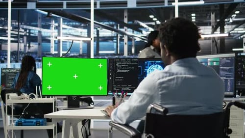 Data Center Admin in Wheelchair Using AI Node Tree Software on Green Screen PC