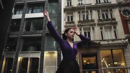Elegant Woman Dancing in Urban Setting