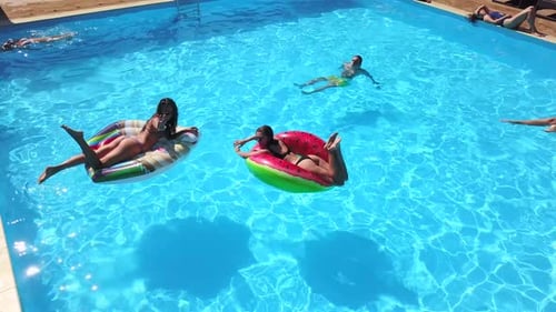Aerial of Friends Having Party in Swimming Pool with Inflatable Flamingo Swan Mattress Happy Young