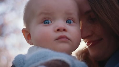 Loving Parent Kisses Adorable Baby on the Head