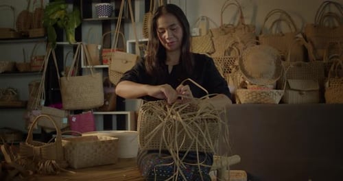 Woman Weaves Basket in Home Workshop