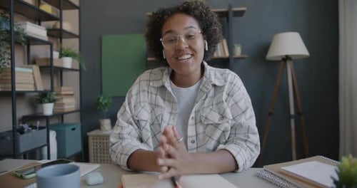 Young Adult Talking at Her Desk at Home
