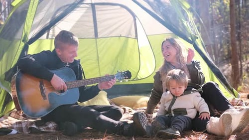 Happy Family Camping, Man Plays Guitar