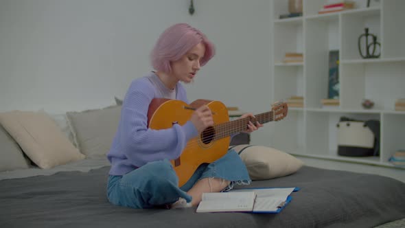 Thoughtful Charming Woman Songwriter with Guitar Writing Lyrics Into ...