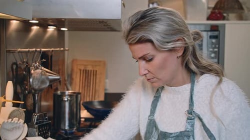 Young woman preparing a home cooked meal in her kitchen