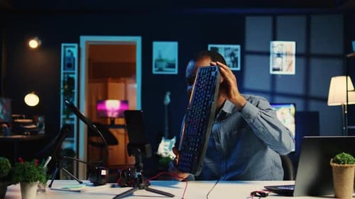 Man Live Streaming with Computer and Headphones