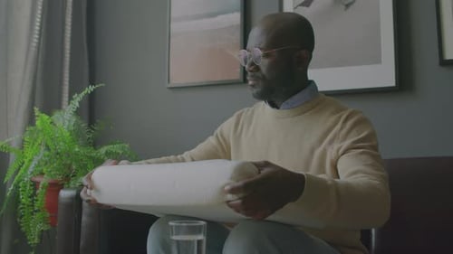 African American Man Examining Orthopedic Pillow in Sleep Clinic