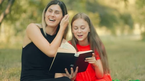 Woman and Child Reading a Book in the Park