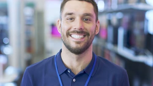 Smiling Young Man Giving Thumbs Up in Store