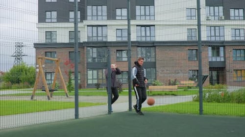 Practicing Ball Skills on City Streets with Coach and Players Group of Players Honing Basketball