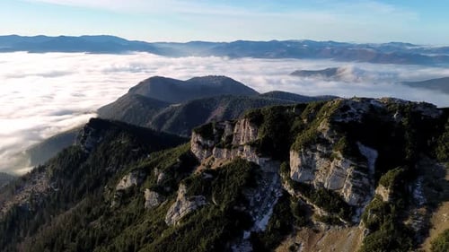 Aerial View of Mountainous Landscape with Forests Valley Full of Fog