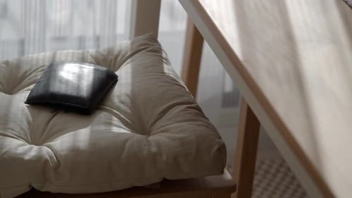 Soft Cushion on a Chair with a Wallet Resting Nearby Lost Wallet Concept
