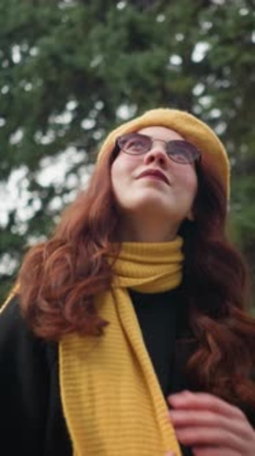 Elegant Lady in Yellow Beret Gazing Up in Autumn Park