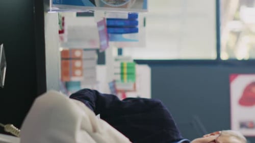 Senior Man at Pharmacy Counter Gives Prescription