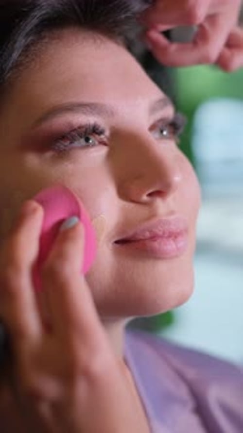 Woman Getting Makeup Applied with Makeup Sponge