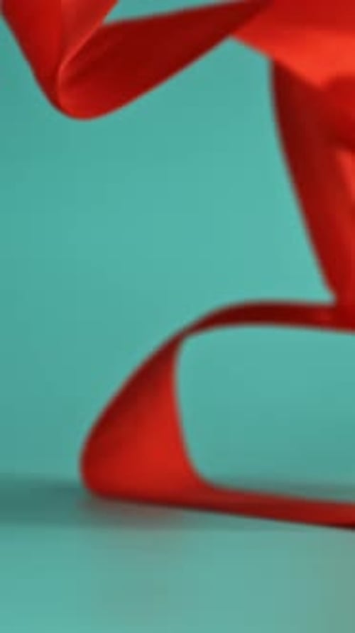 A Red Ribbon Falls on the Table Filmed on a Highspeed Camera at 1000 Fps