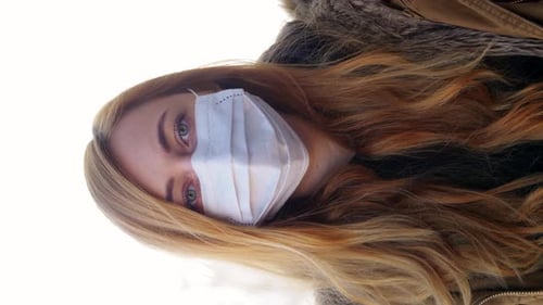 Woman with face mask looking at the camera