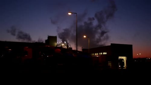 Black smoke emitted from the building exhaust during the night - medium shot