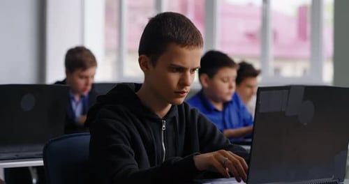 Smart Teen Boy Student Working With PC In ComputerBased Classroom Of High School Portrait