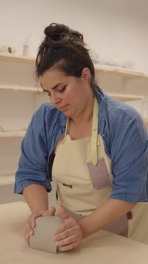 Ceramist Woman Kneading Clay in Workshop