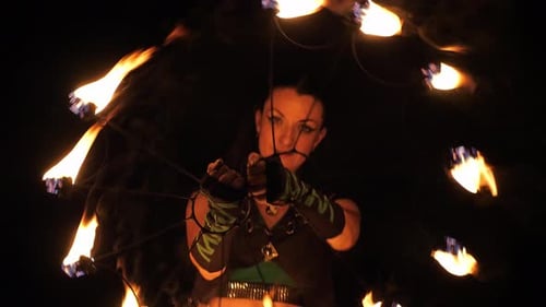 Woman Performing Fire Dance with Fiery Prop