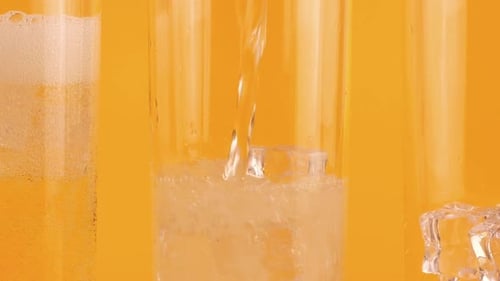 Refreshing Drink Poured into Glass with Ice Cubes