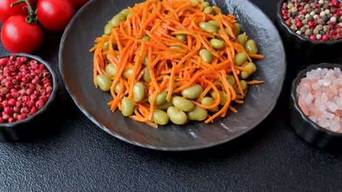Asian salad with edamame beans, carrots, tofu, and spices. Edamame and carrot salad