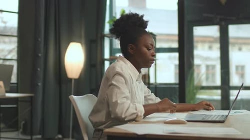 African American Business Woman Sitting on Chair Use Laptop Typing on Keyboard in Office Look