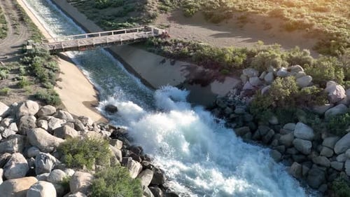 Aerial of water flowing down a spillway at a dam