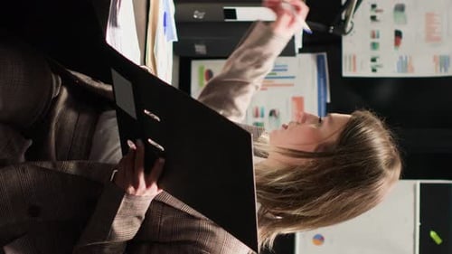 Vertical Video Officer Reviews Evidence in Office Space