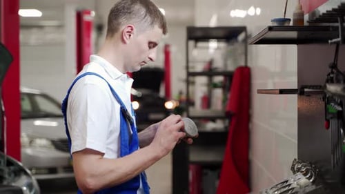 Professional Mechanic Assembles Engine Parts in Workshop Installs Piston Rings Inspects Liner