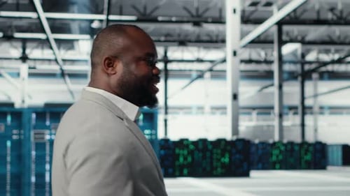 Engineer Walking in Data Center Facility Doing Inspection on Hardware Tech