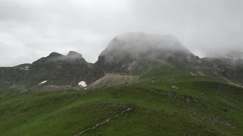 Epic rock in the clouds. Aerial view. Incredible mountain panorama. Mountains in the clouds.