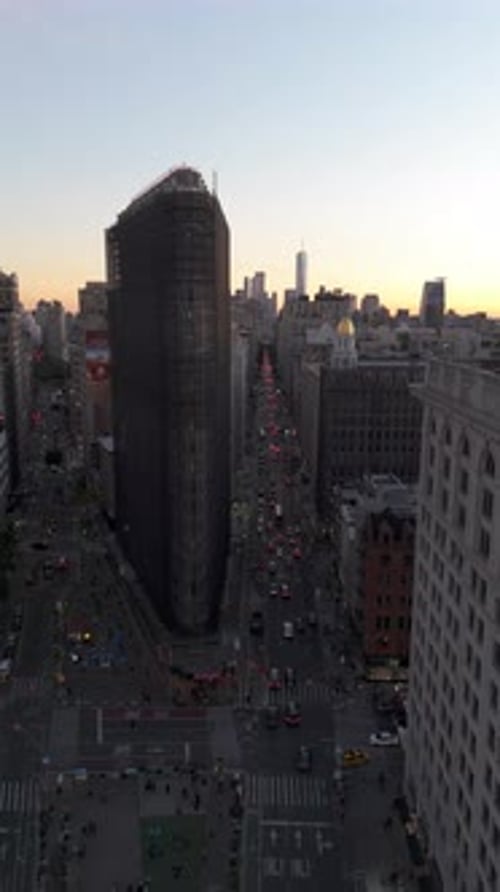 Vertical Aerial Views Highlight Flatiron Building Surrounded By Lively Yellow Taxis in Fifth Avenue