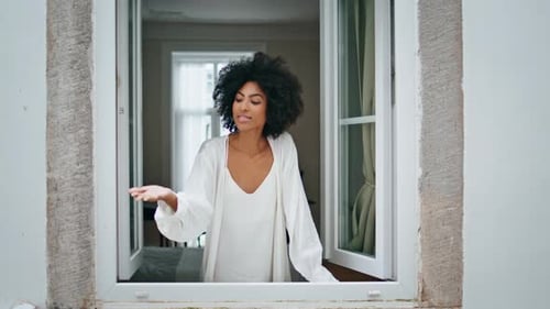 Curly Lady Catching Raindrops at Window Place. Closeup Young African Woman Watching