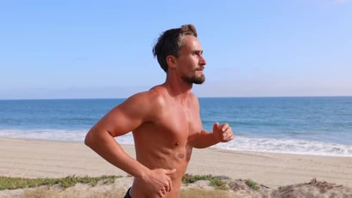 Athletic Man Exercising At The Beach