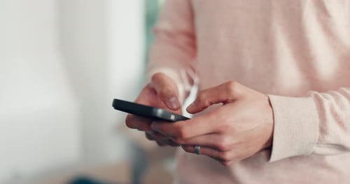 Man Using Smartphone Indoors in Bright Light