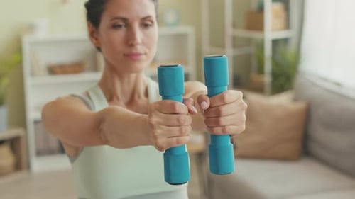 Woman Exercising at Home with Dumbbells