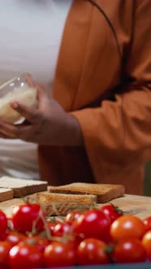 Close Up of Female Chef Using Cream Cheese Spread on a Bread Slice