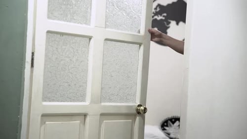 Person closing the bedroom door
