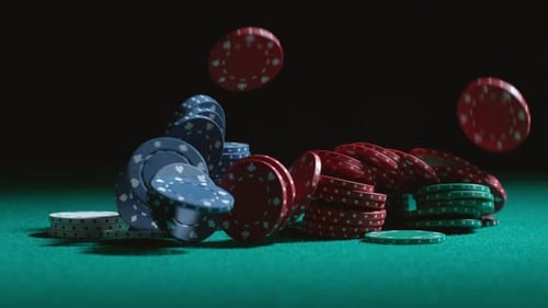 Poker Chips Falling onto Green Table in Slow Motion