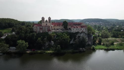 Drone view of Benedictine abbey on the rocky hill and cliff at Vistula River on a sunny day. Tyniec,