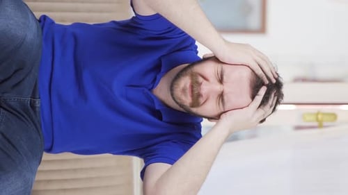 Bearded Man Holds Head Suffering From Headache