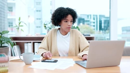 Woman Working with Laptop and Cellphone at Desk