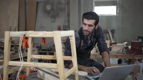 Carpenter is working at workshop.