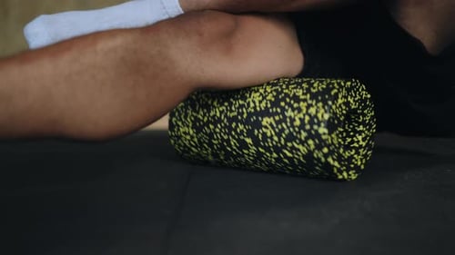 Man Using Foam Roller For Muscle Recovery
