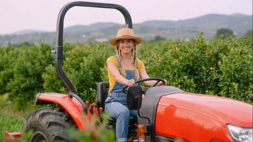 White Female Farmer Driving Red Tractor Orchard Owner