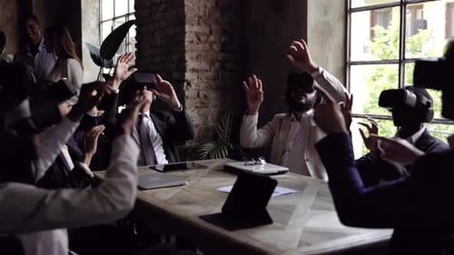 Multiracial business people wearing virtual reality futuristic goggles inside office